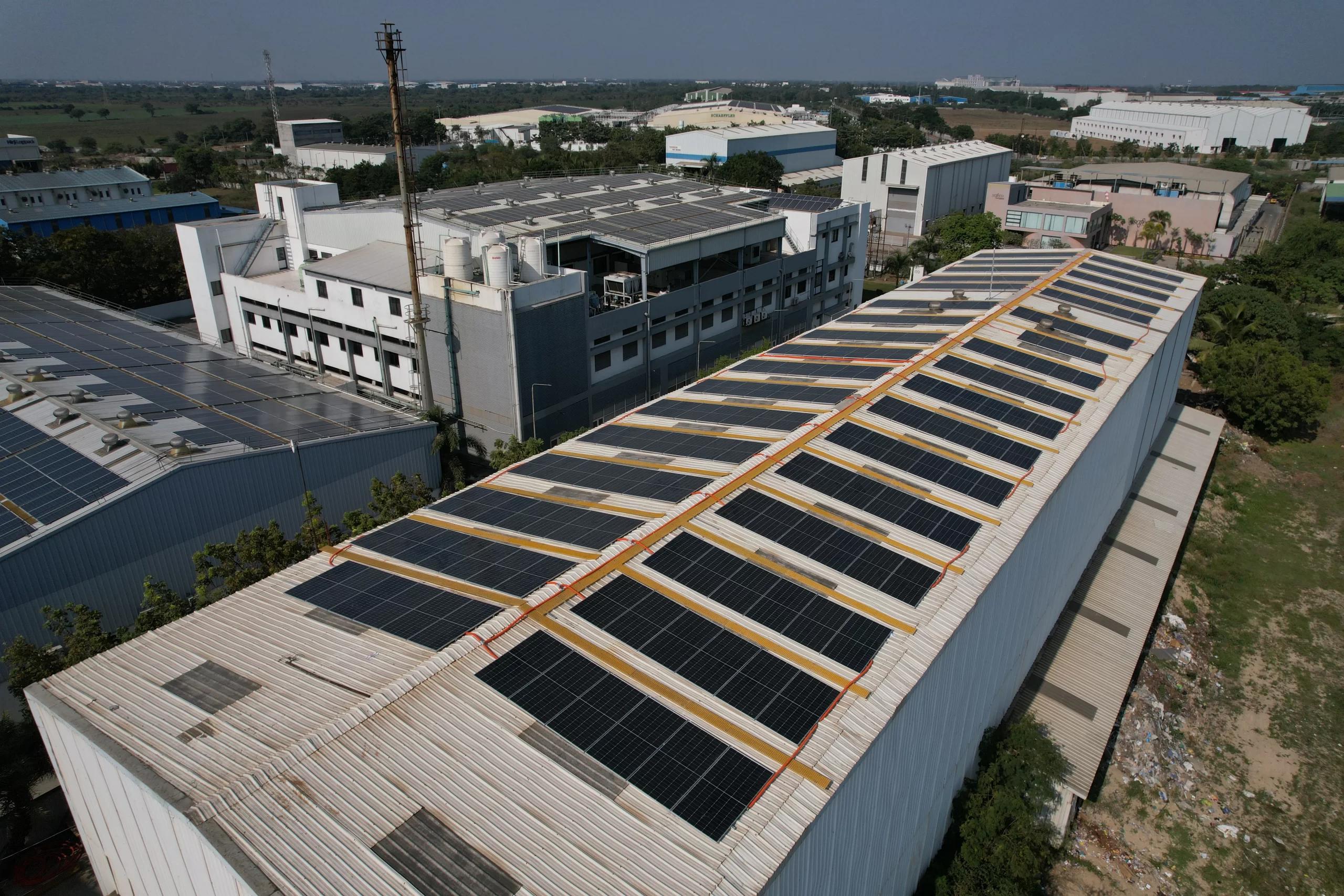 Angled aerial of a large industrial warehouse with rooftop solar arrays